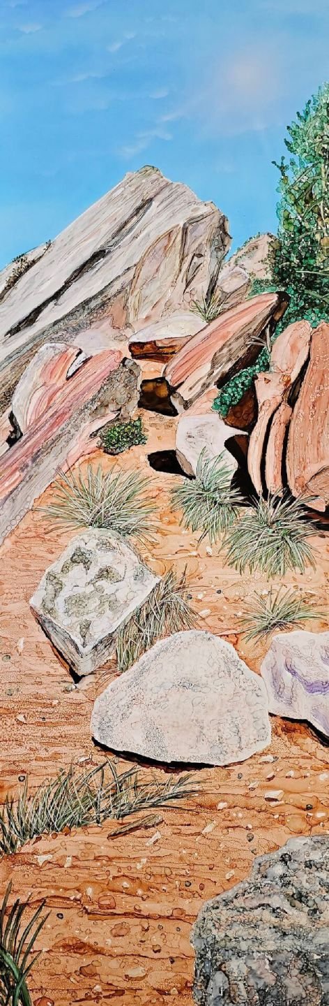 Alcohol ink artwork of sunlit desert rock formations with sandstone layers, grasses, and a bright blue sky